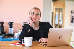 a woman bored at a laptop to represent an under-performing staff member