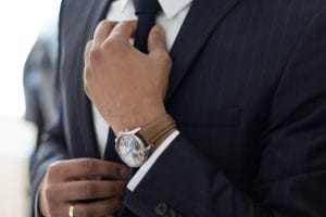 a business man tightening his tie