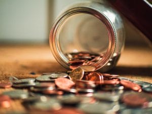 a jar with coins spilling out to represent what to do after making partner