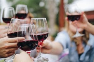 People drinking wine whilst networking at a Christmas party.