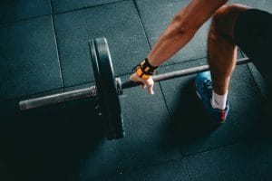 a man lifting weights to represent playing to your strengths