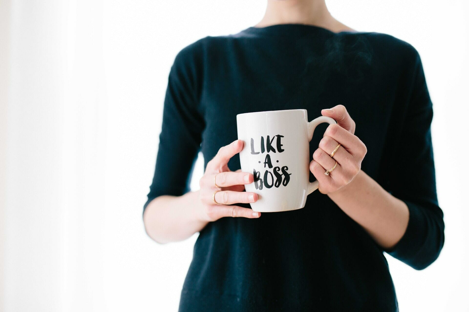 A woman holding a mug to represent how do you succeed in a male-dominated environment