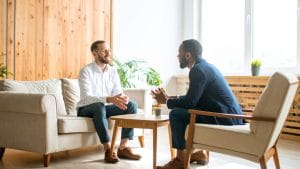 Two people sat around a table having a conversation